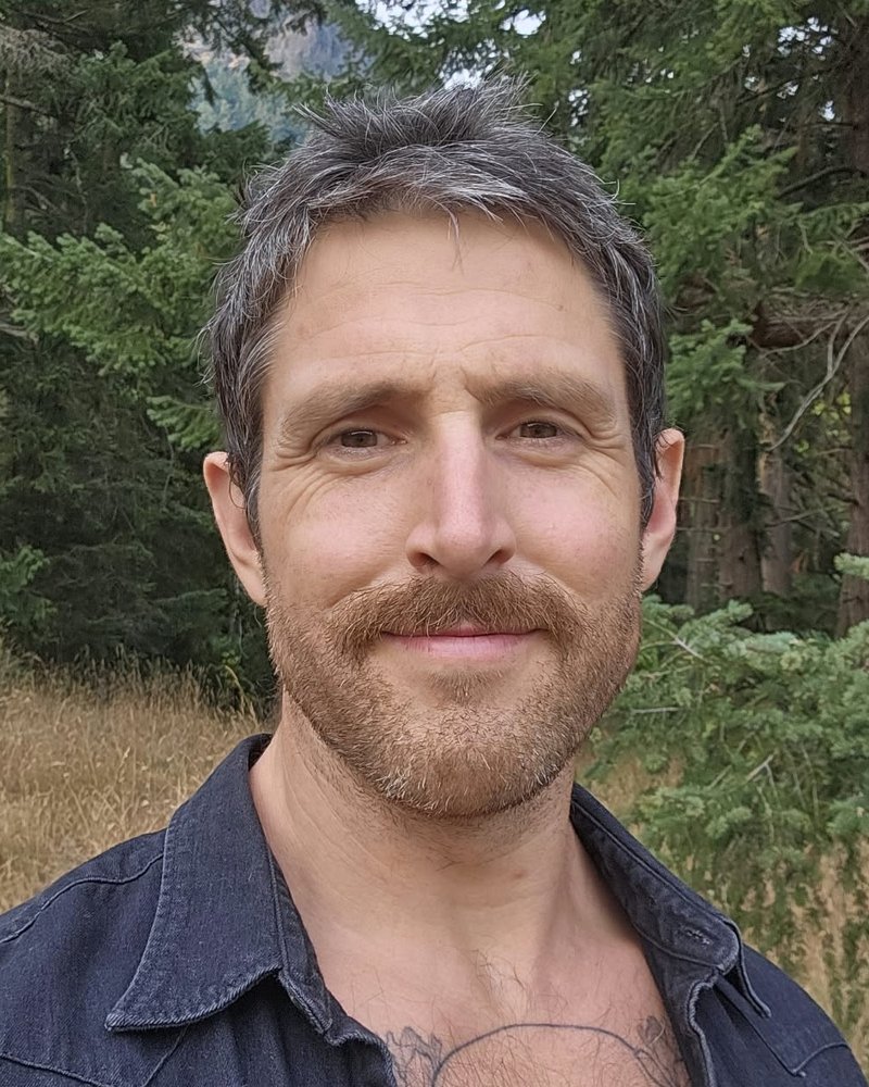 Ryan Haché, standing in a forest clearing on Salt Spring Island.
